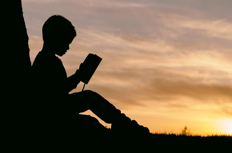 child reading outdoors