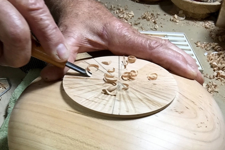 Tom Goldschmid working a wooden bowl by hand.