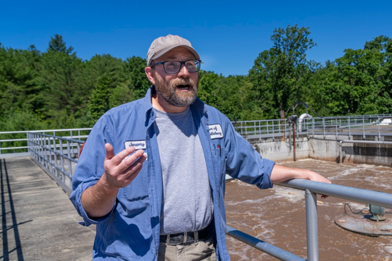 Jeremy Rathbun stands in front of one of the 400,000 gallon Sequencing Batch Reactor basins at the wastewater treatment facility in Middlebury, Vermont. These biological reactors process approximately 1,000,000 gallons per day. (Terry Allen, Barn Raiser)