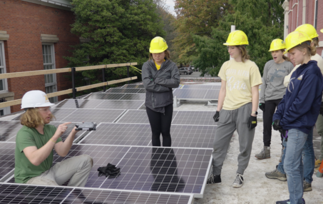 Allegheny College students installing solar panels