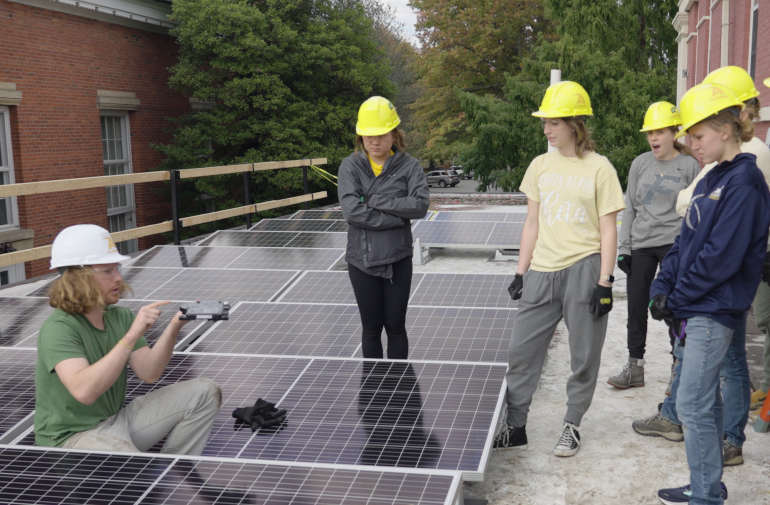 Allegheny College students installing solar panels