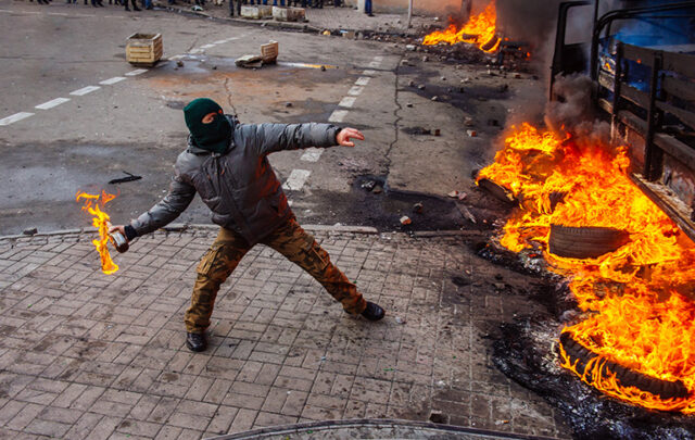 Person throwing Molotov Cocktail