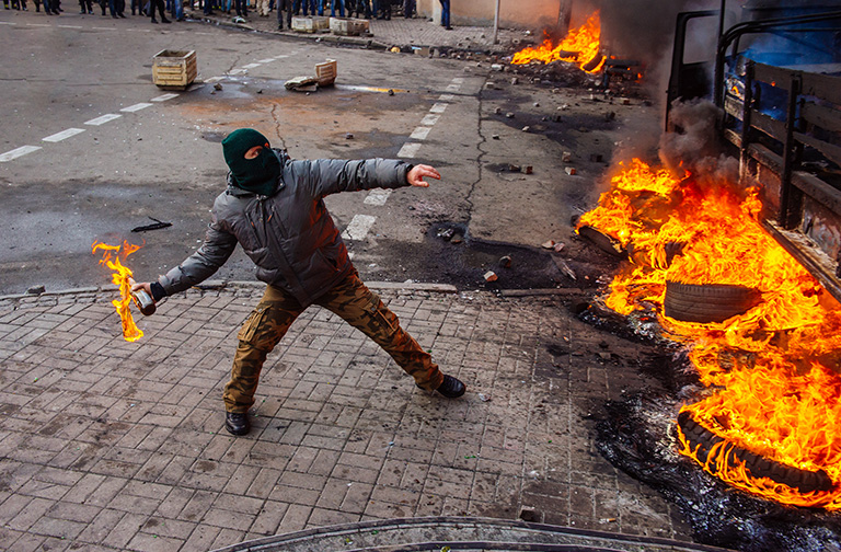 Person throwing Molotov Cocktail