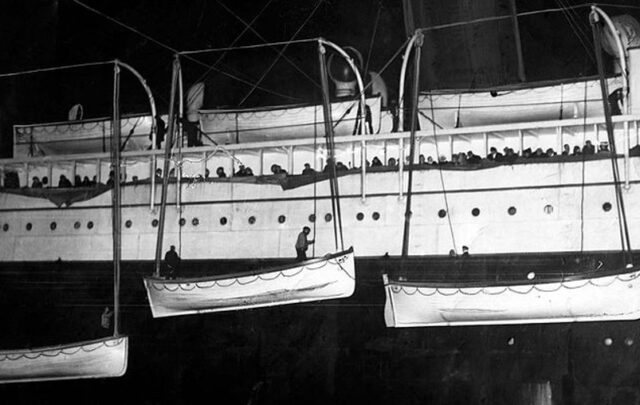 Lifeboats from the RMS Titanic are uploaded to the RMS Carpathia in the hours after the sinking (1912).