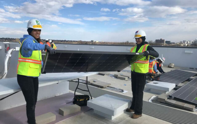 Grid Alternatives WEBuild (Women in Energy) rooftop solar installation with National Tribal Program Co-Executive Director Tanksi Clairmont.